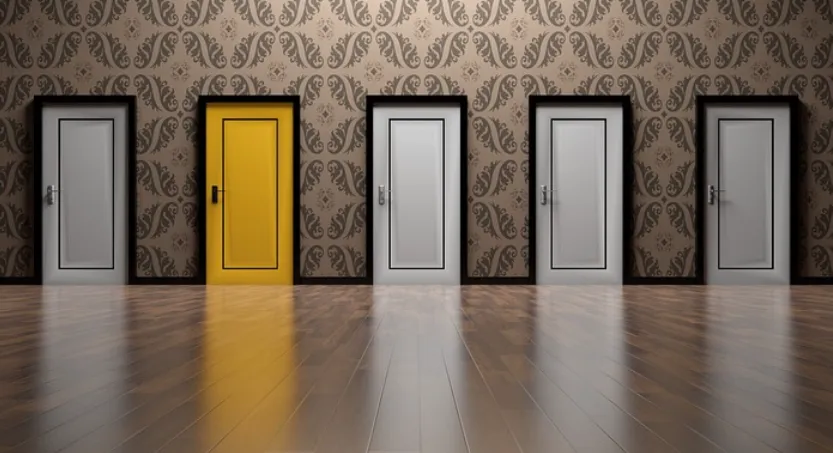 A row of doors with one yellow door