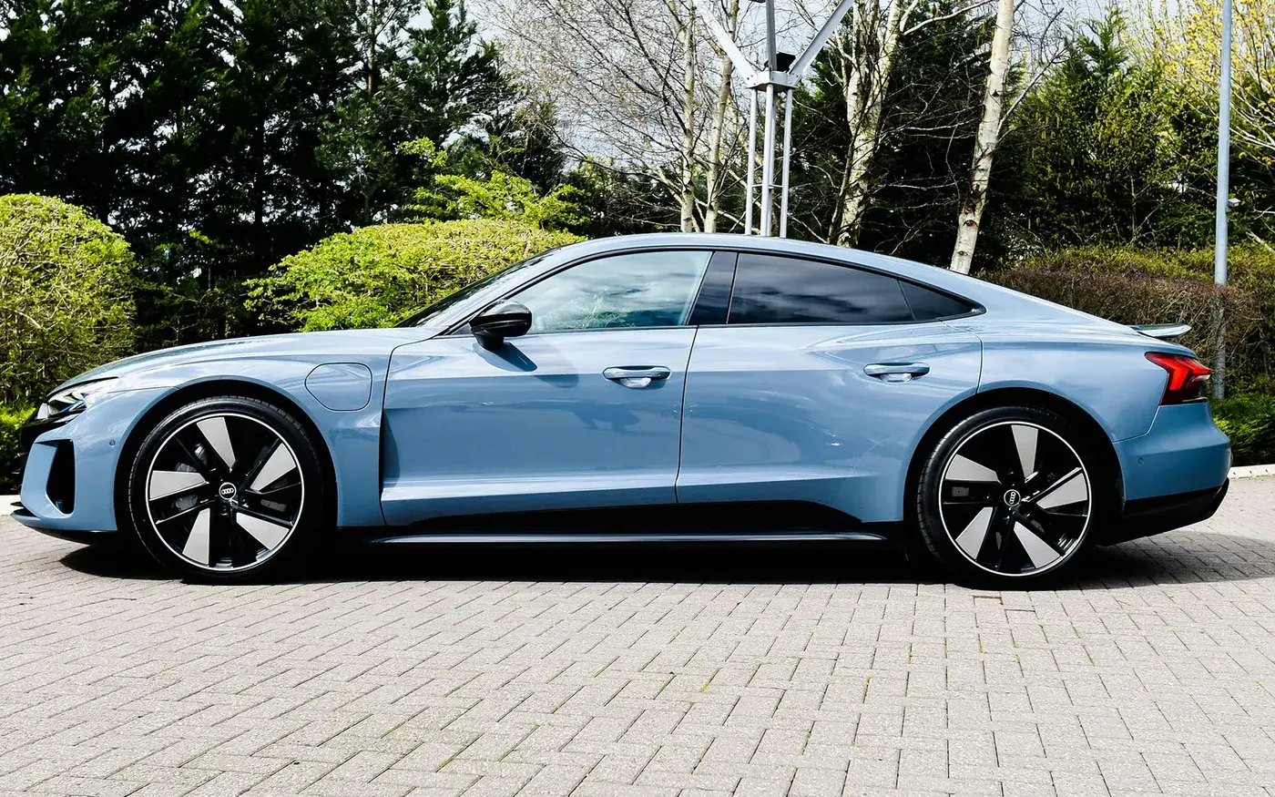 Electric sedan parked on a paved drive