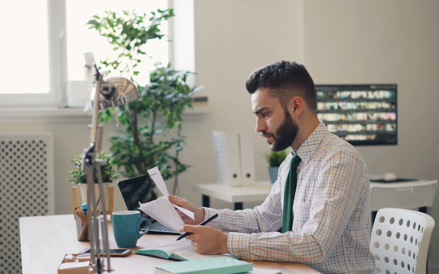 Executive reviewing a report at a desk