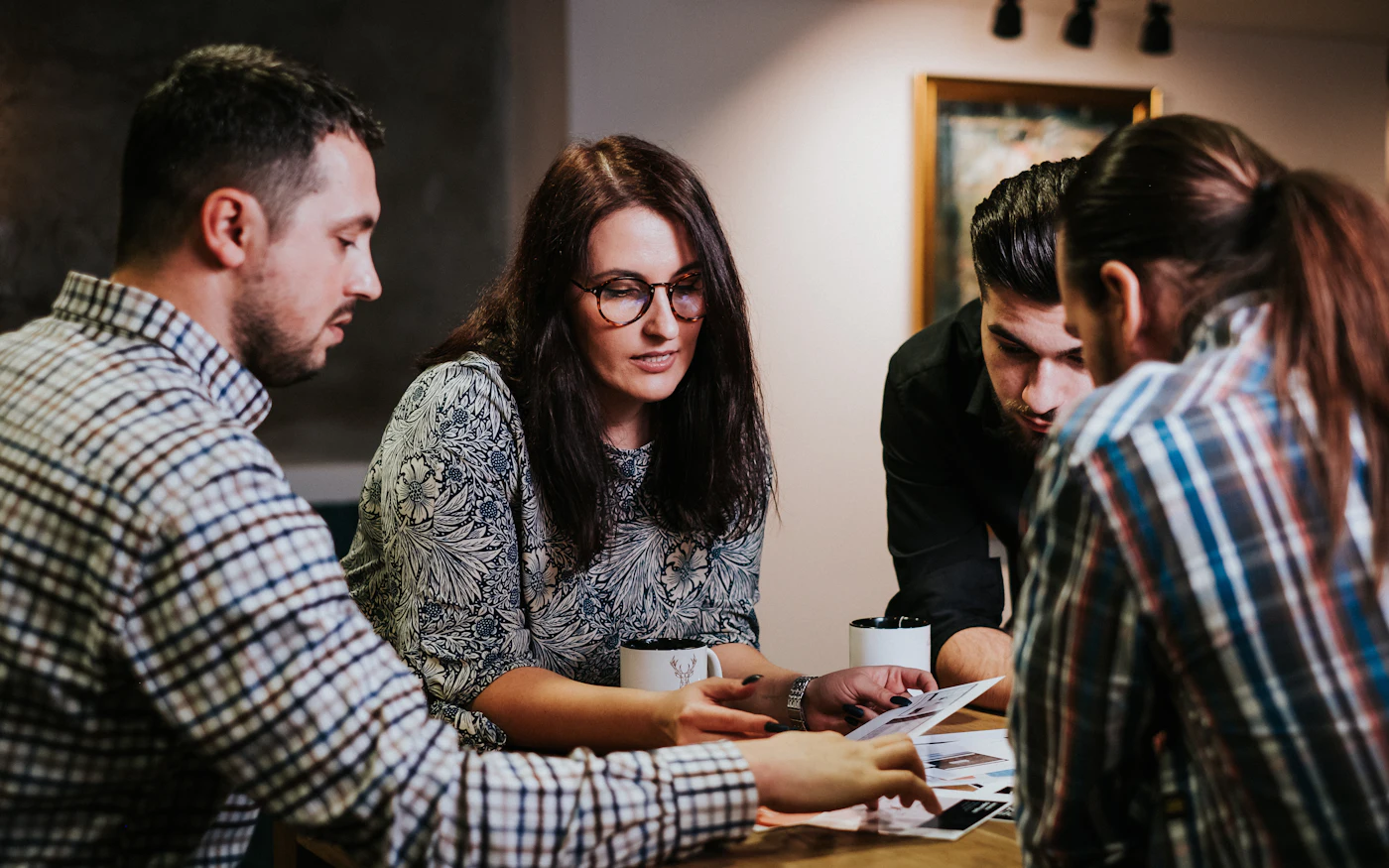 Marketing team reviewing documents at a table