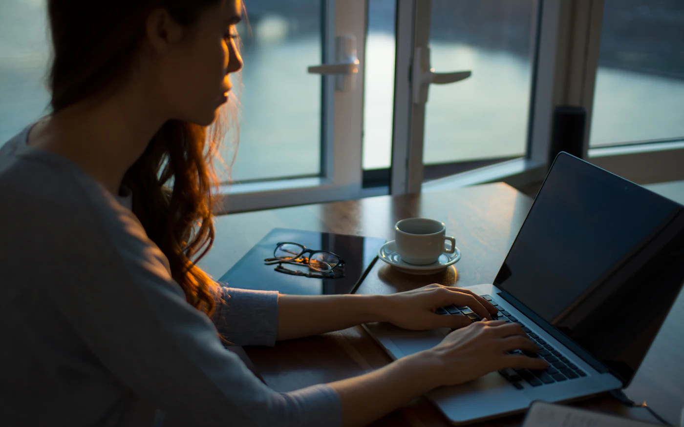 Professional typing a question on a laptop