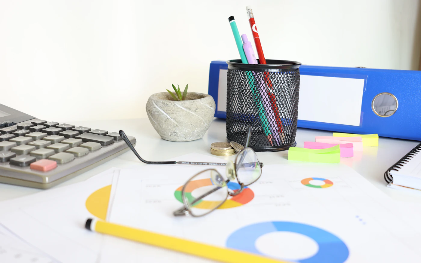 Research charts, notes and glasses on a desk